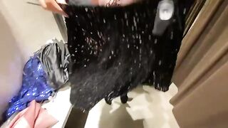 A girl chose a new outfit in the changing room and got cum on her tits