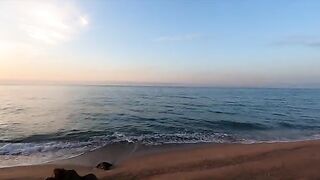 A girl is having sex on the beach with someone she met there