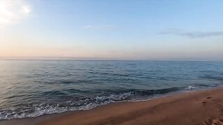 A girl is having sex on the beach with someone she met there