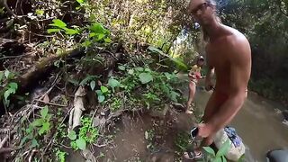 A man and a woman are fucking in the jungle river