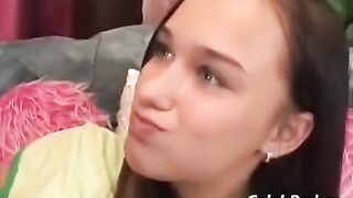 A cute young girl has sex with an adult man on the couch