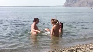Three nudists with a cleft on the public beach