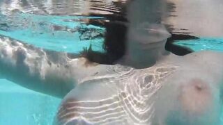 A naughty woman plays with a dildo in the swimming pool