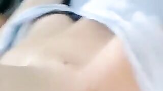 A half-naked girl lies and caresses her body with her hands in a sensual way