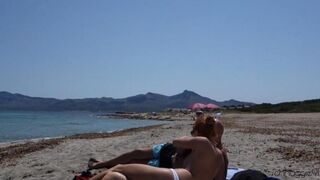 Blonde woman makes a blowjob on the beach with complete dissolute libidinousness