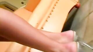 Sexual beauty in a leather chair achieves a solo orgasm