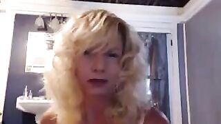 A aged woman caresses herself in the bathroom with a vibrator
