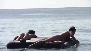 A stunning woman has no clothes on the beach and sunbathes