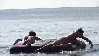 A stunning woman has no clothes on the beach and sunbathes