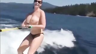 Topless girl skiing on water, her tits dripping wet and absolutely free
