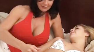 Two girls are having fun with a strap-on, exploring new sensations and bringing each other pleasure