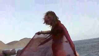 A girl with small boobs gets them wet while undressing outdoors