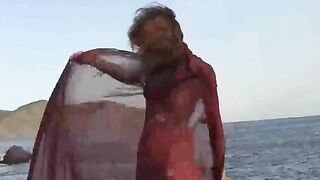A girl with small boobs gets them wet while undressing outdoors
