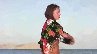 The member shows a naked girl on the beach