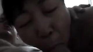 The Chinese woman practices her skills with a man on the bed