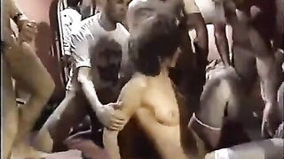A young slut in stockings is having fun with a group of guys