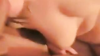 A woman spreads her legs to show her naked pussy with a protruding clitoris