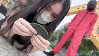 Asian girl participates in a twisted version of Squid Game