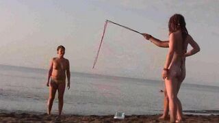 A naked girl is having fun on the beach in a hot way