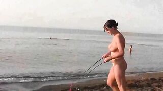 A naked girl is having fun on the beach in a hot way