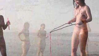 A naked girl is having fun on the beach in a hot way