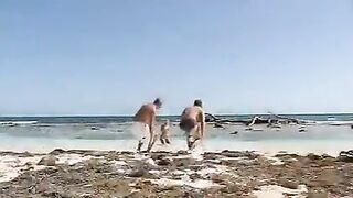 Two guys fuck blondie on the beach in an intense threesome