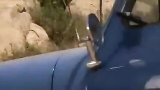 A hot chick is getting fucked right in the car on the road