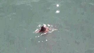 A couple enjoying each other naked right on the sea