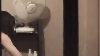 The guy admires himself in the mirror, not leaving anything to chance