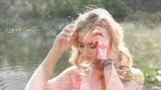 Blonde girl masturbates tenderly on the shores of the lake