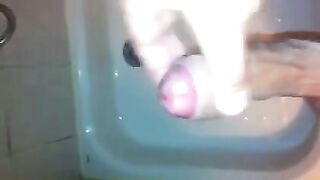 The kid caresses his dick under the shower jet