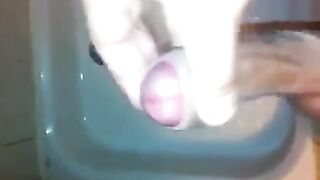 The kid caresses his dick under the shower jet