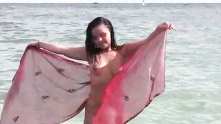 A hot girl is bathing naked in the sea, it’s a very erotic view