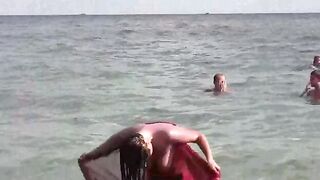 A hot girl is bathing naked in the sea, it’s a very erotic view