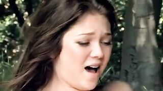 A pair of lesbians are having fun on a picnic in the park with other people around