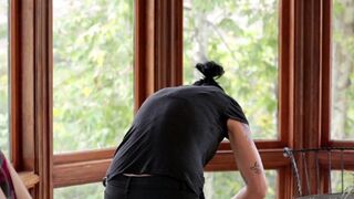 A cute Vietnamese girl was fucked in the kitchen by a horny lesbian with a strap-on