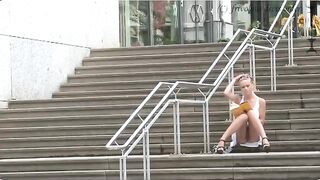 A girl walks the city streets without panties
