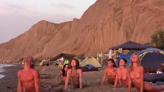 A group of naked beauties are playing volleyball on the nude beach