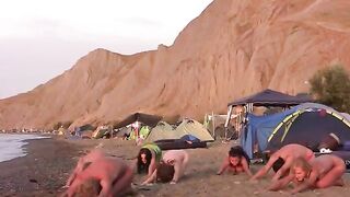 A group of naked beauties are playing volleyball on the nude beach