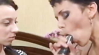 A mother teaches her daughter how to perform a blowjob using a strapon