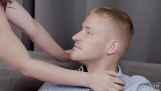 A man presents a gift to his loved one on the couch