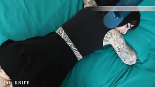A hot girl with tattoos is using a vibrator in the most seductive way ever