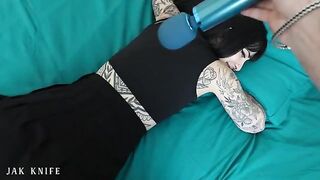 A hot girl with tattoos is using a vibrator in the most seductive way ever