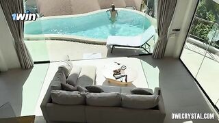 A lonely girl smokes and plays with her pussy in the swimming pool