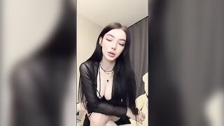 A girl in pink underwear plays with a big dildo