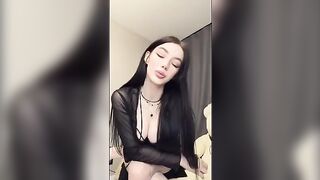 A girl in pink underwear plays with a big dildo
