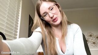 A girl with glasses, Emma Ruby, is relaxing while drawing on her lips
